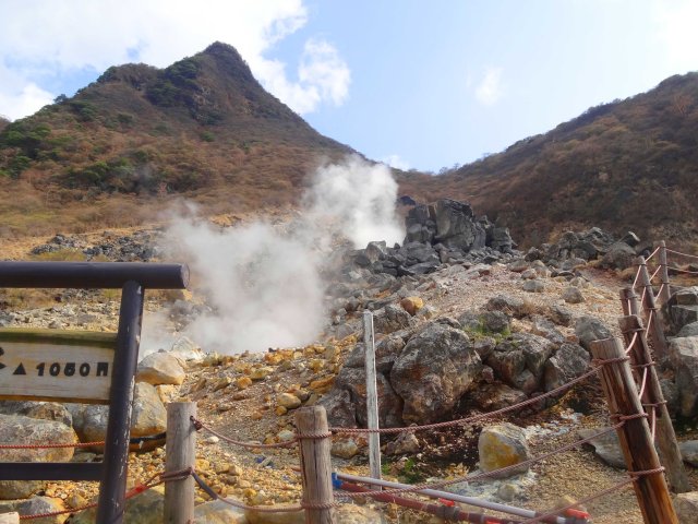 Steam rises from holes in the ground.
