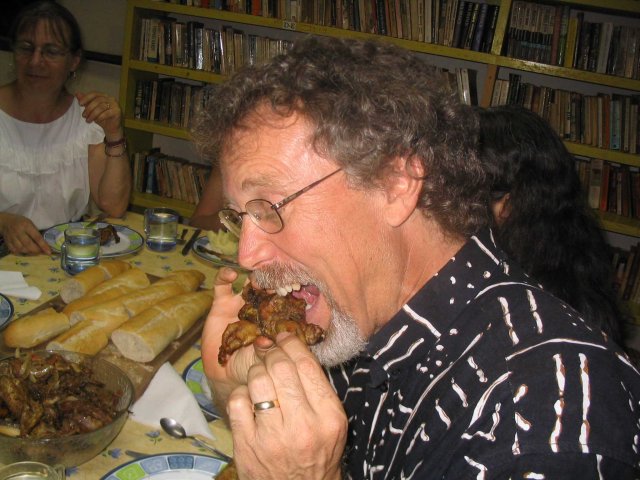 My kindest of kind host in Ouagadougou tucks into some roast chicken.