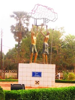 Statue in Bobo of two men holding up Burkina Faso