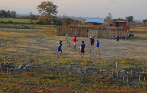 Kids play football as train closes in on Schwenyaung.