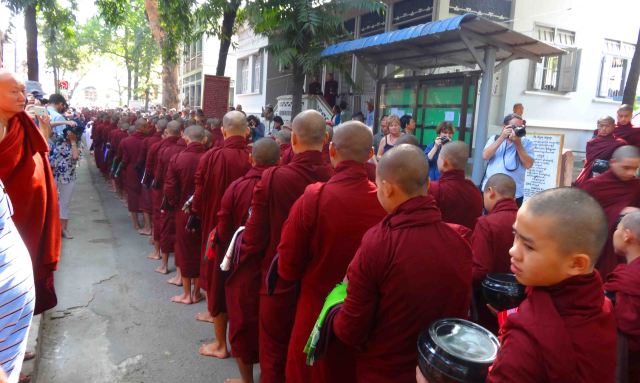Monks line up for lunch at a temple in Mandalay whilst tourists outnumber them and take their photo. Yes. Like me.