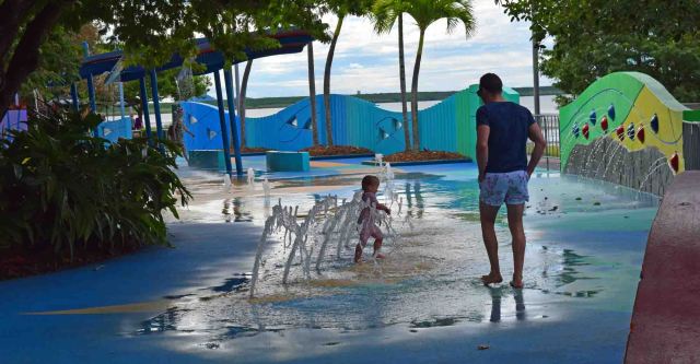 Kid has fun with the water play equipment provided. 