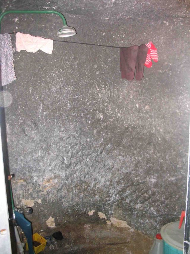 Shower in a house in Kandovam where the houses are made in volcanic rock. 